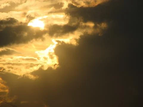 Sunset sky with clouds and sun rays. Beautiful nature background. Stock Photos