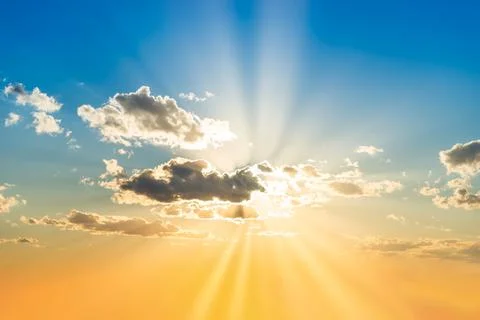 Sunset sky with clouds and sun Stock Photos