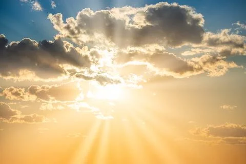Sunset sky with clouds and sun Stock Photos