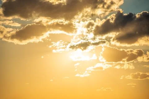 Sunset sky with clouds and sun Stock Photos