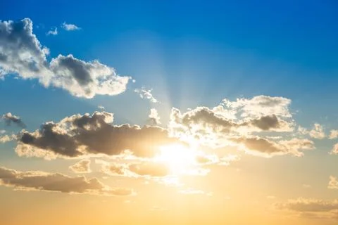 Sunset sky with clouds and sun Stock Photos