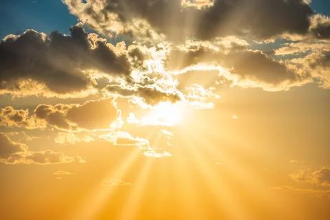 Sunset sky with clouds and sun Stock Photos