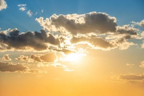 Sunset sky with clouds and sun Stock Photos