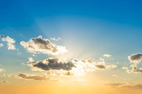 Sunset sky with clouds and sun Stock Photos