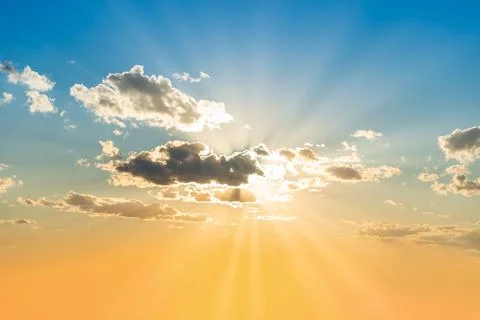 Sunset sky with clouds and sun Stock Photos