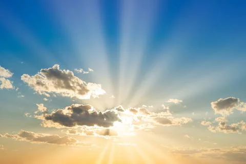 Sunset sky with clouds and sun Stock Photos