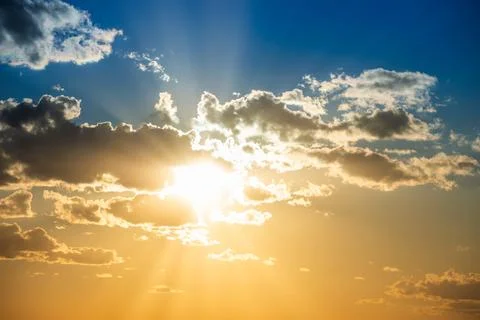 Sunset sky with clouds and sun Stock Photos