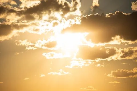 Sunset sky with clouds and sun Stock Photos