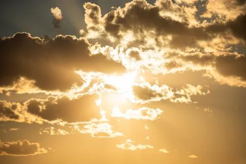 Sunset sky with clouds and sun Stock Photos