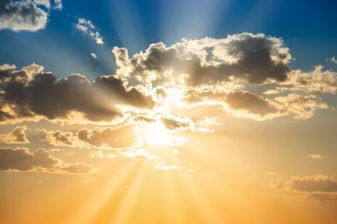 Sunset sky with clouds and sun Stock Photos