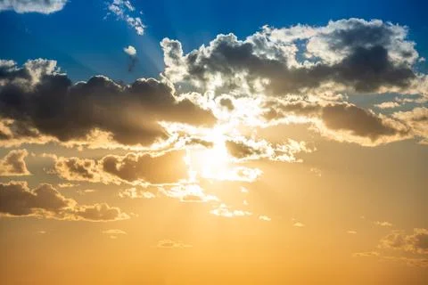 Sunset sky with clouds and sun Stock Photos