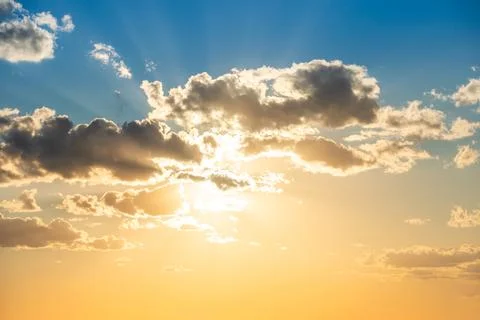 Sunset sky with clouds and sun Stock Photos