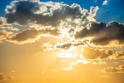 Sunset sky with clouds and sun Stock Photos