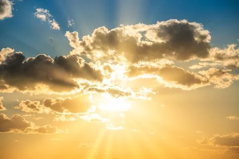 Sunset sky with clouds and sun Stock Photos