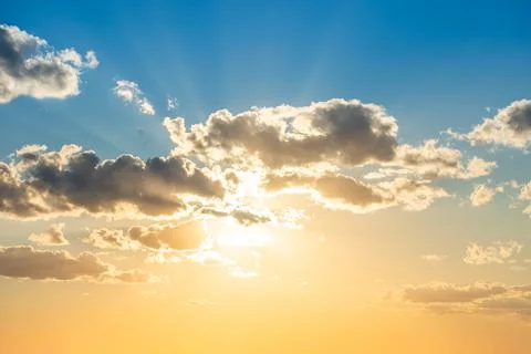Sunset sky with clouds and sun Stock Photos