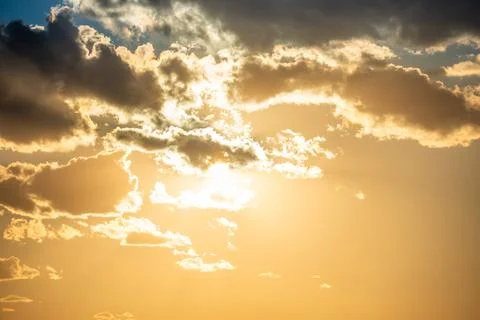 Sunset sky with clouds and sun Stock Photos