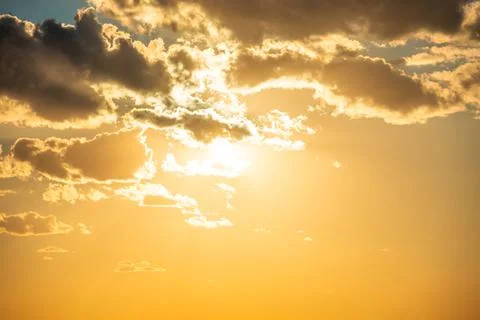 Sunset sky with clouds and sun Stock Photos