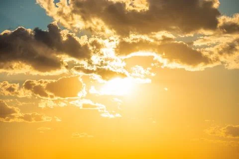 Sunset sky with clouds and sun Stock Photos