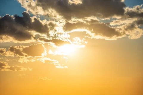 Sunset sky with clouds and sun Stock Photos