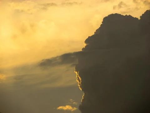 Sunset sky with clouds and sunbeams, natural background. Stock Photos
