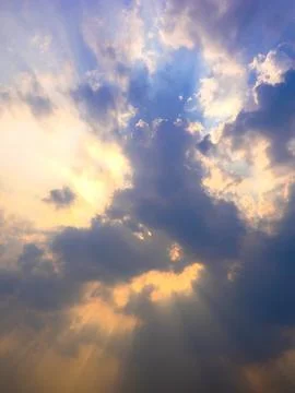 Sunset sky with clouds and sunbeams. Nature background. Stock Photos