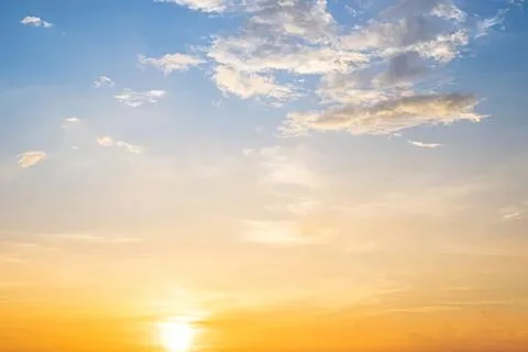 Sunset sky with clouds and warm colors during evening Stock Photos