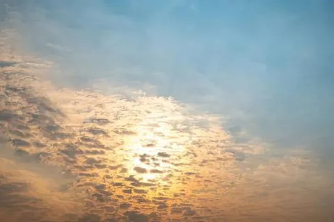 Sunset sky with clouds and warm sunlight in the evening Stock Photos