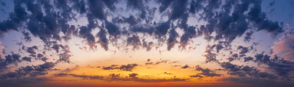 Sunset sky with clouds. Dramatic beautiful cloudscape. Stock Photos