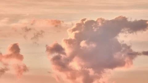 Sunset sky. Clouds float across the rosy sky. They are illuminated by the set Stock Footage 155805732