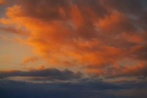 Sunset sky clouds orange and blue Stock-Fotos