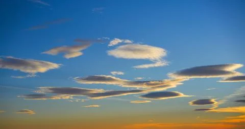 Sunset sky clouds in orange and blue Stock Photos