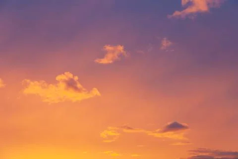 Sunset sky with clouds in orange and purple colors Stock Photos
