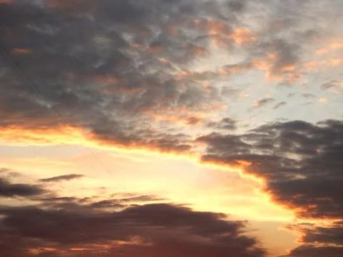 Sunset sky with clouds in red yellow purple colors Stock Photos