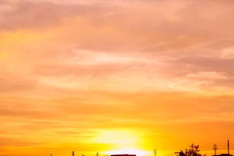 Sunset sky clouds trees orange. Colorful abstract background with fiery orang Stock Photos