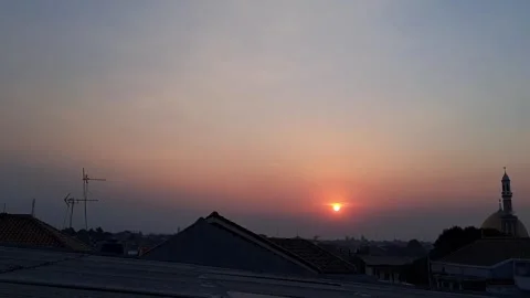At sunset, the sky is colored in shades of red, orange, and yellow. Stock Footage 341213093
