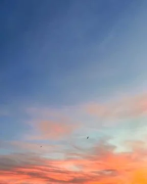 Sunset sky with colorful clouds background concept. Dramatic evening sunset Stock Photos