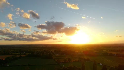 Sunset sky countryside panorama with glowing cloud formations. Aerial view Stock Footage 340904718