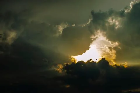 The Sunset Sky is Covered with Clouds. The Dark Thick Clouds and the Light Br Stock Photos
