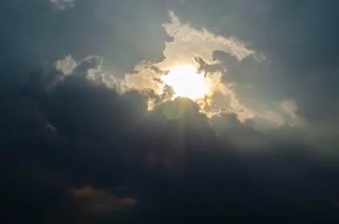 The Sunset Sky is Covered with Clouds. The Dark Thick Clouds and the Light Br Stock Photos