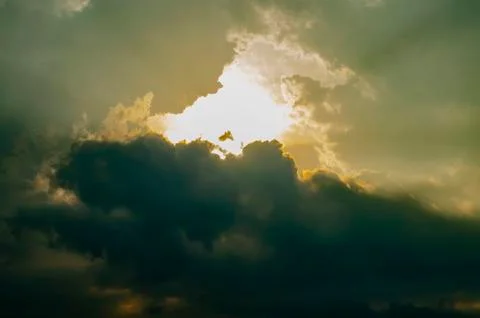 The Sunset Sky is Covered with Clouds. The Dark Thick Clouds and the Light Br Stock Photos