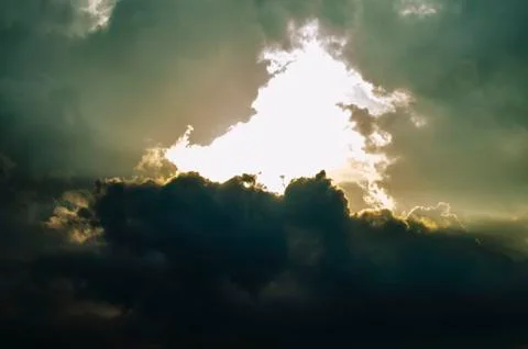 The Sunset Sky is Covered with Clouds. The Dark Thick Clouds and the Light Br Stock Photos