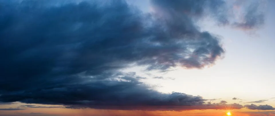 Sunset sky with dark clouds. Stock Photos