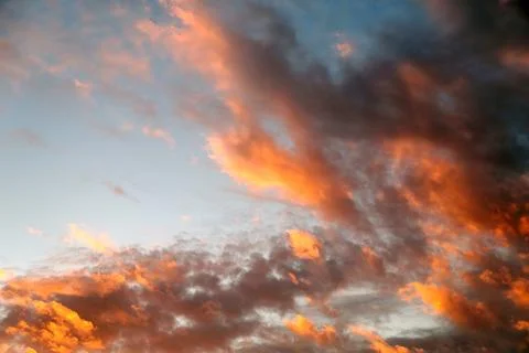 Sunset sky with dark orange clouds for background Stock Photos