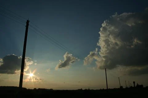 Sunset Sky with Dramatic Clouds and Power Lines Stock Photos