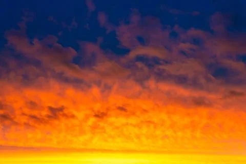 Sunset sky, dramatic clouds on colorful sky Stock Photos