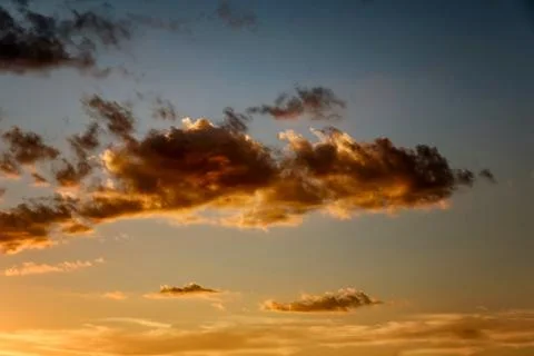 Sunset sky with dramatic orange clouds Stock Photos