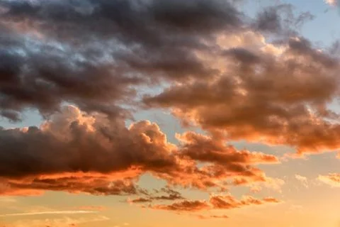 Sunset sky with dramatic orange clouds Stock Photos