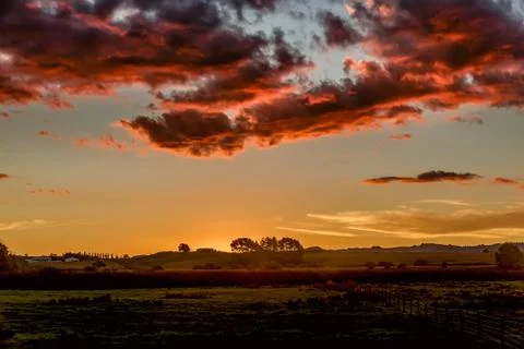 Sunset sky with dramatic orange clouds Stock Photos
