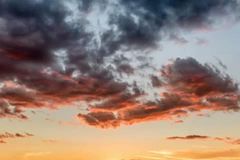 Sunset sky with dramatic orange clouds Stock Photos
