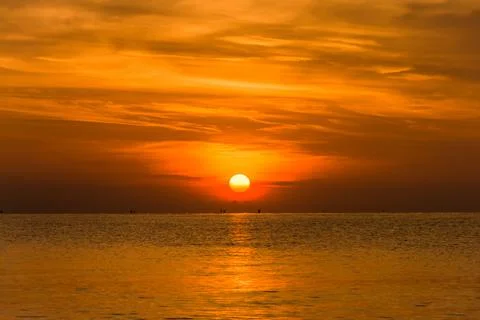 Sunset sky with dramatic sunset clouds over the sea. Beautiful sunrise over O Stock Photos